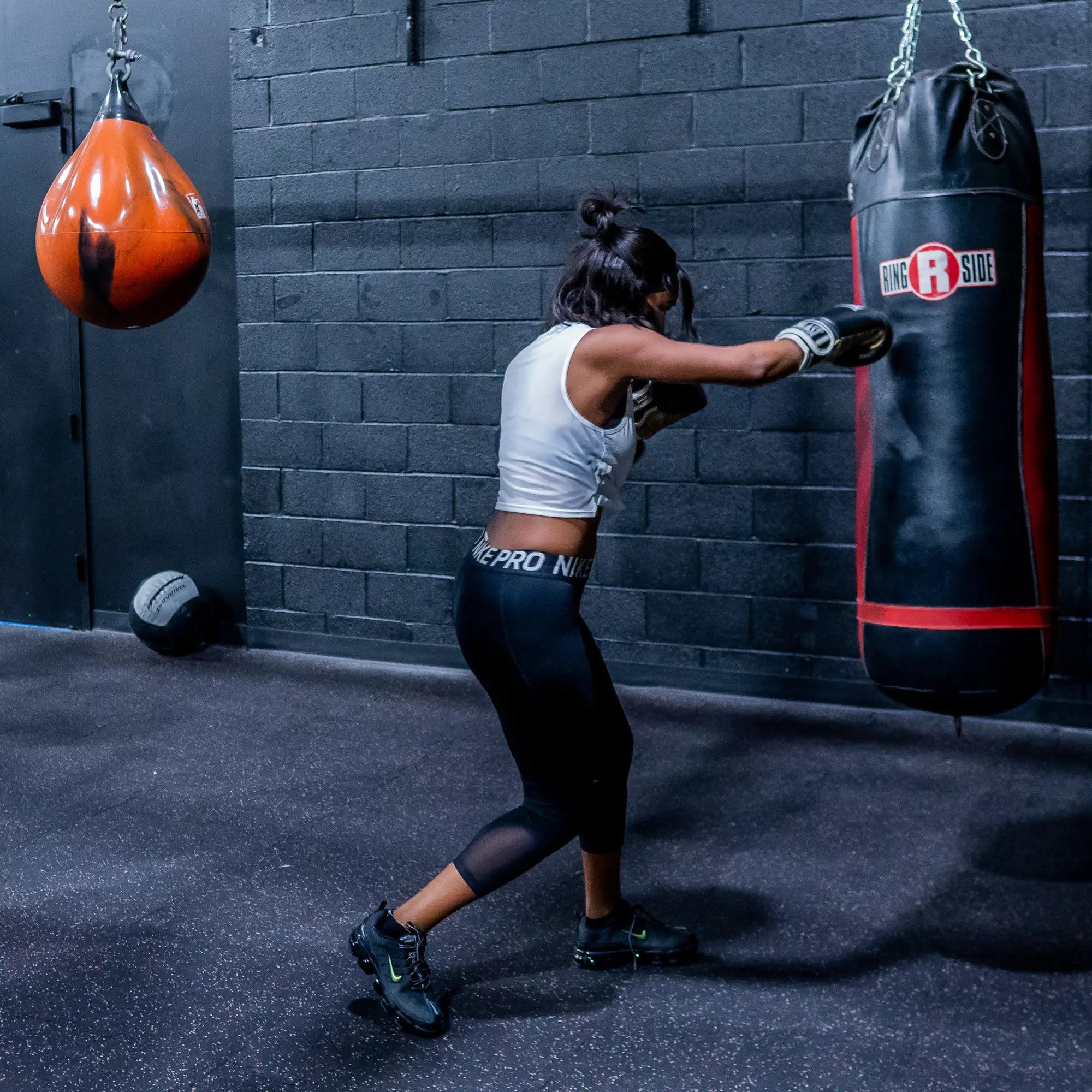 Women boxing with punching bag